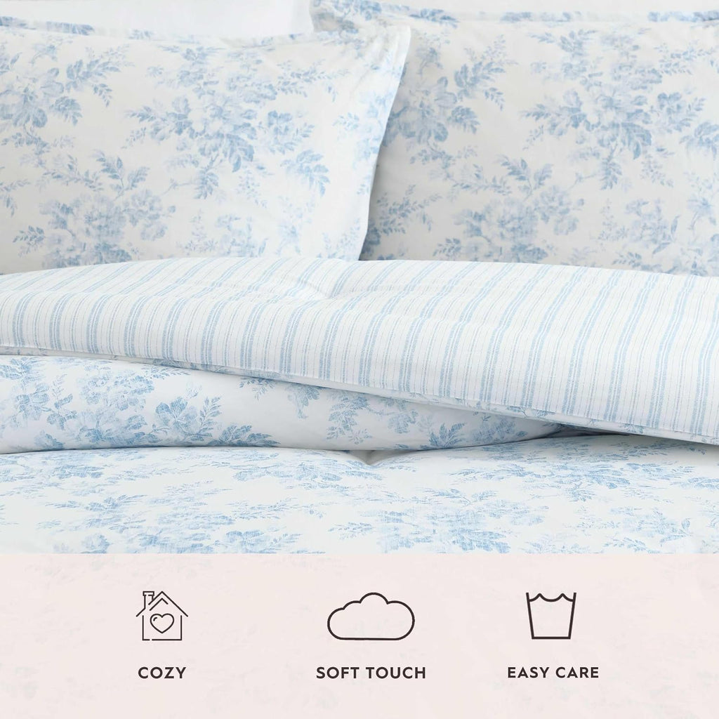 Laura Ashley - King Bonus Comforter Set, Soft Reversible Bedding Set, 7 Piece Bed Set with Matching Pillowcases, Euro Shams, & Throw Pillow Covers (Annalise Floral/Dilly Dally Stripe Blue)